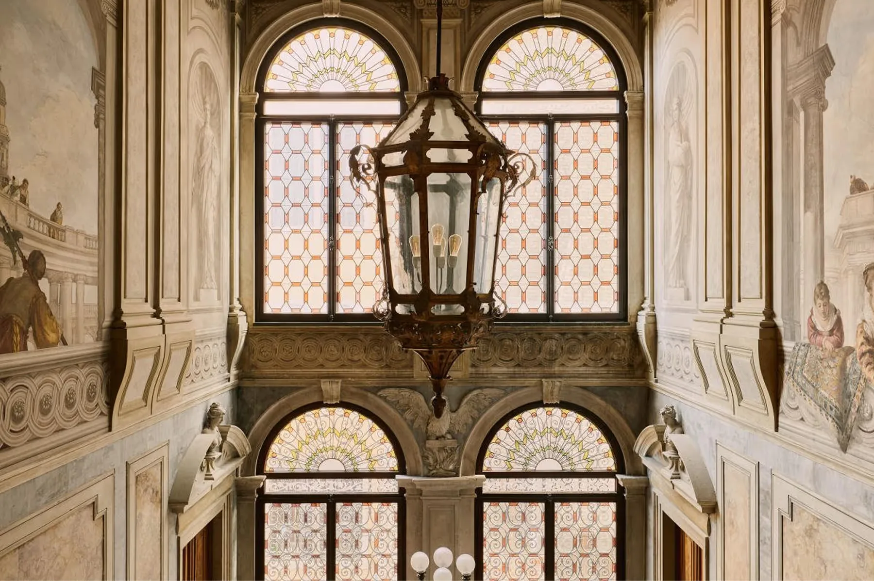 Classical arched windows with columns and lanterns in the palazzo interior courtyard