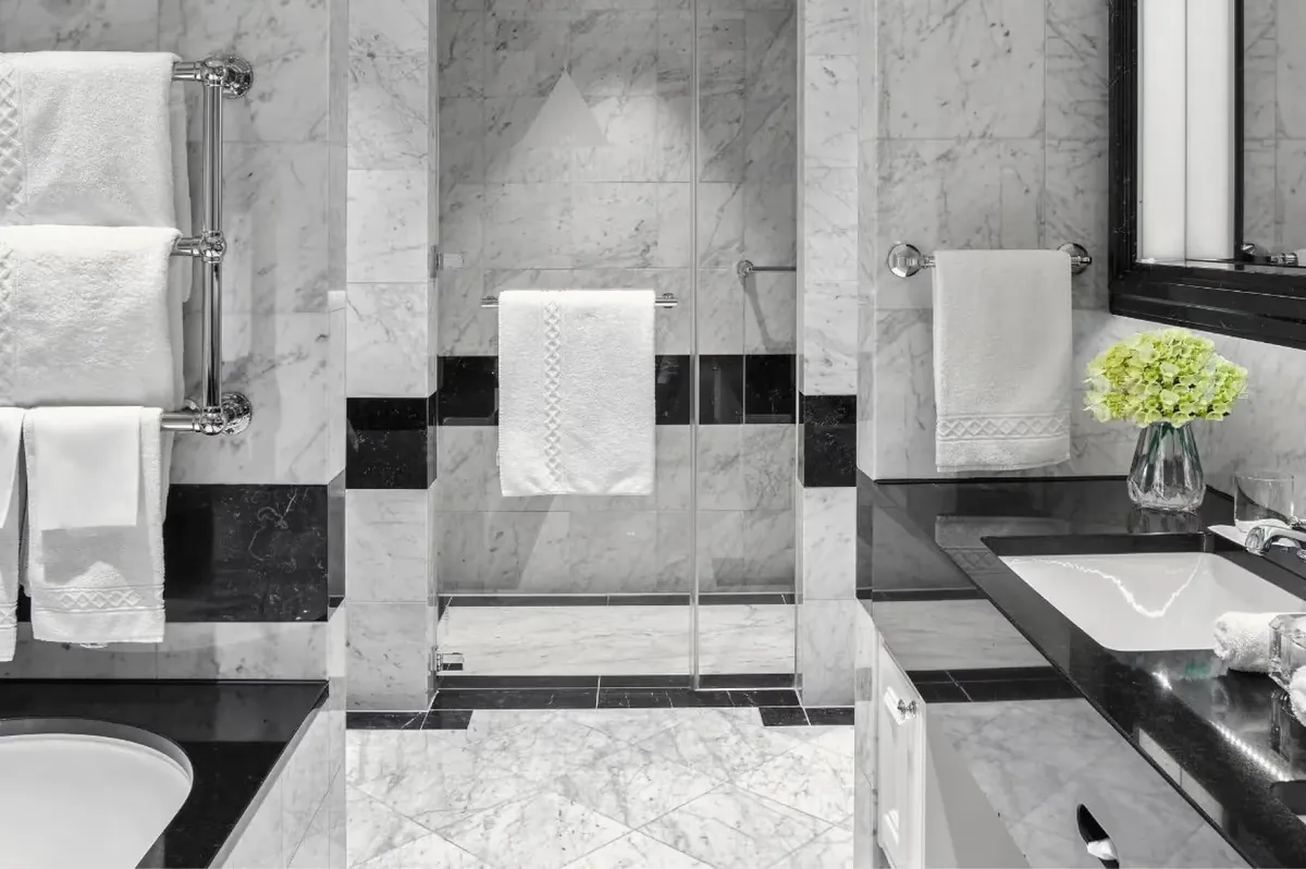 Marble bathroom with black and white geometric tile pattern