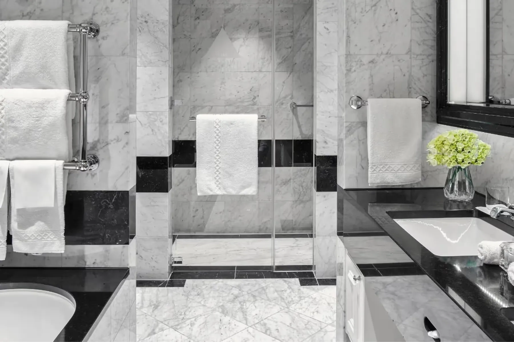 Marble bathroom with black and white geometric tile pattern
