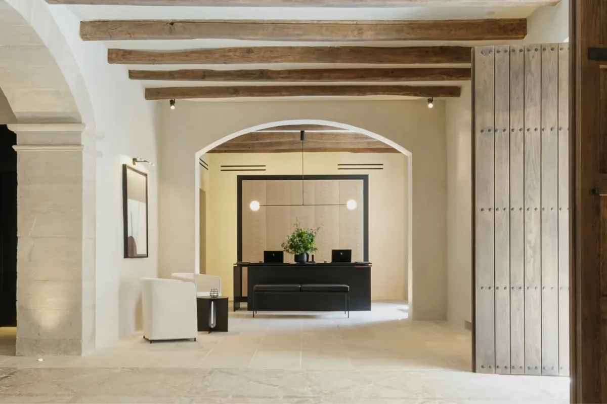 Interior archways with wooden beams framing view through multiple rooms