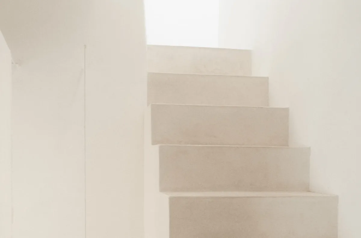 Architectural staircase with recessed steps and soft natural light from above