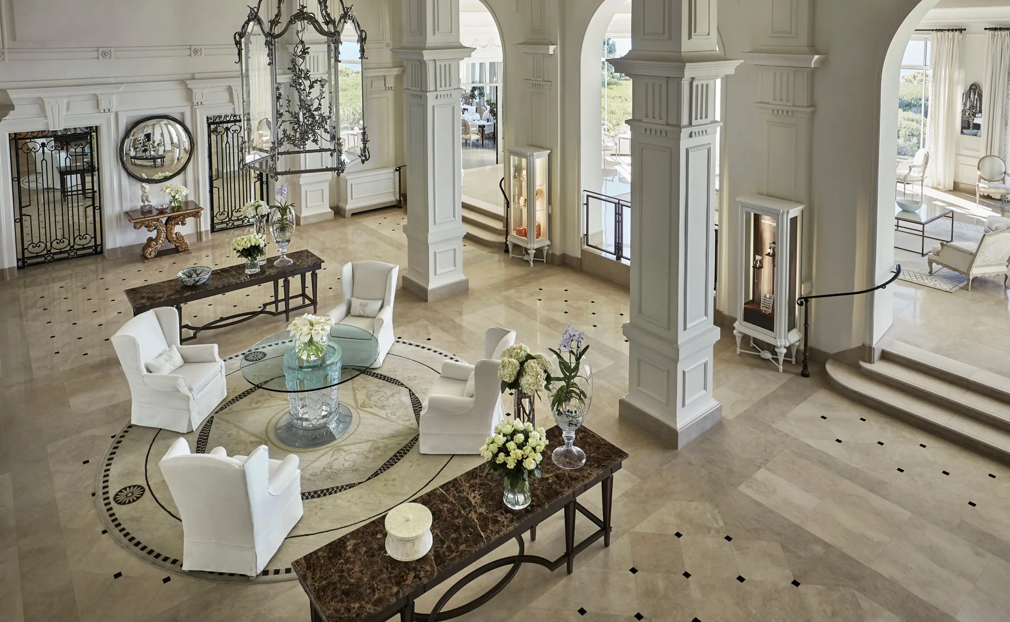 Grand foyer with classical columns, marble floors, and symmetrical layout