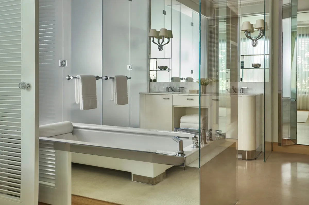 Modern marble bathroom suite with dual vanity and walk-in shower