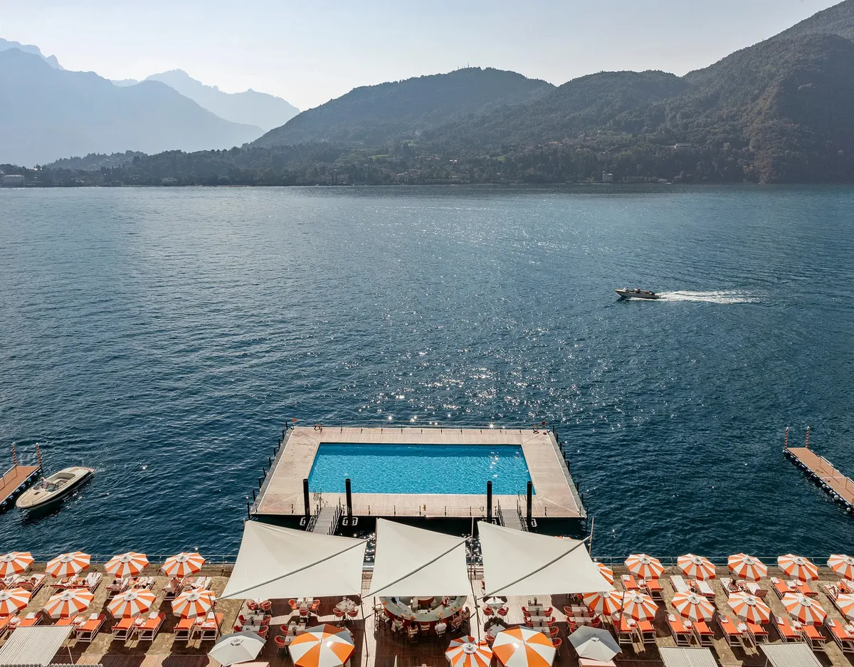 The renowned floating pool on Lake Como with mountain backdrop