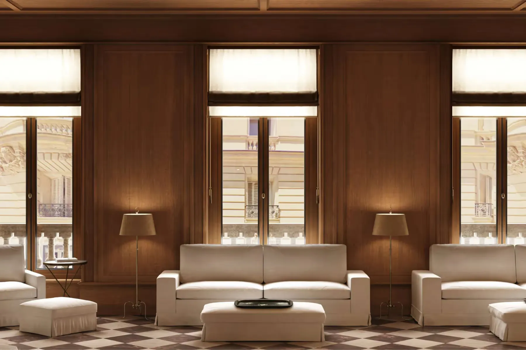 A wood-paneled salon with multiple windows, seating, and a fireplace