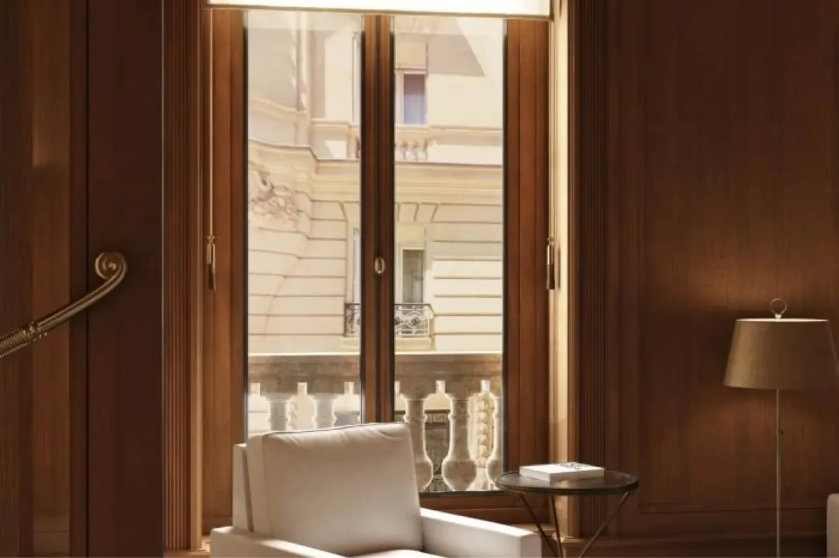 A spa room with warm wood tones, a bed, and modern fixtures