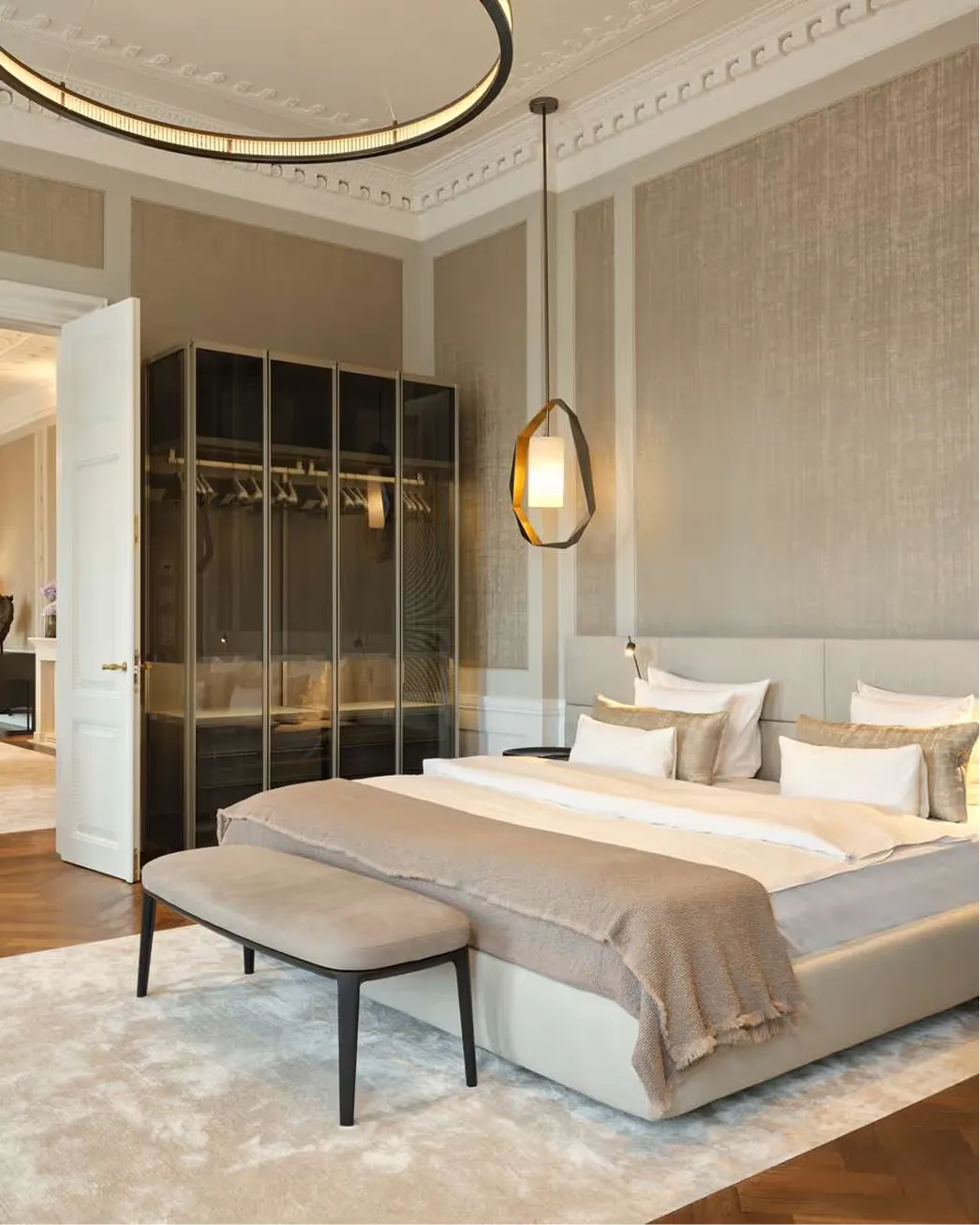 A contemporary suite with ornate plasterwork and hanging brass lights