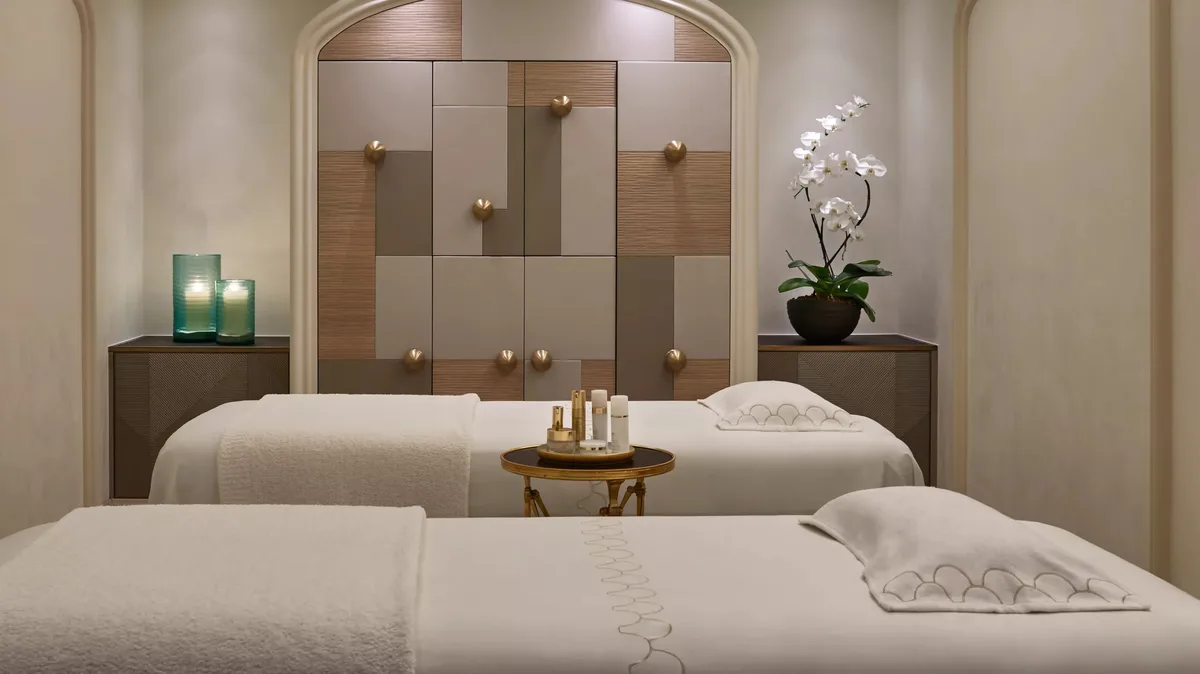 Spa pool area with blue tiles, white loungers, and architectural detailing