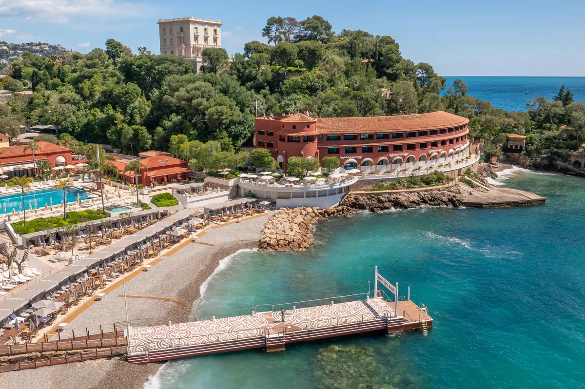 Coastal resort and spa facilities with red-roofed buildings and boat pier