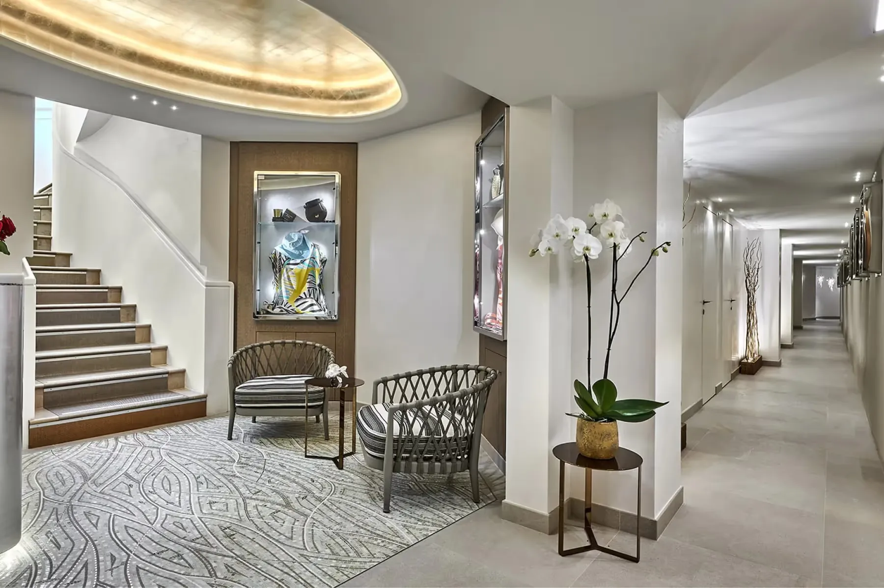 Hotel lobby with curved staircase and classical architecture