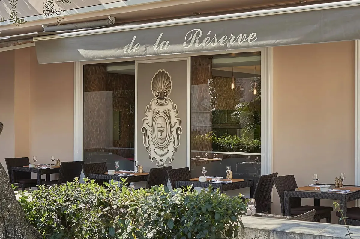 Restaurant storefront with signage and outdoor seating area