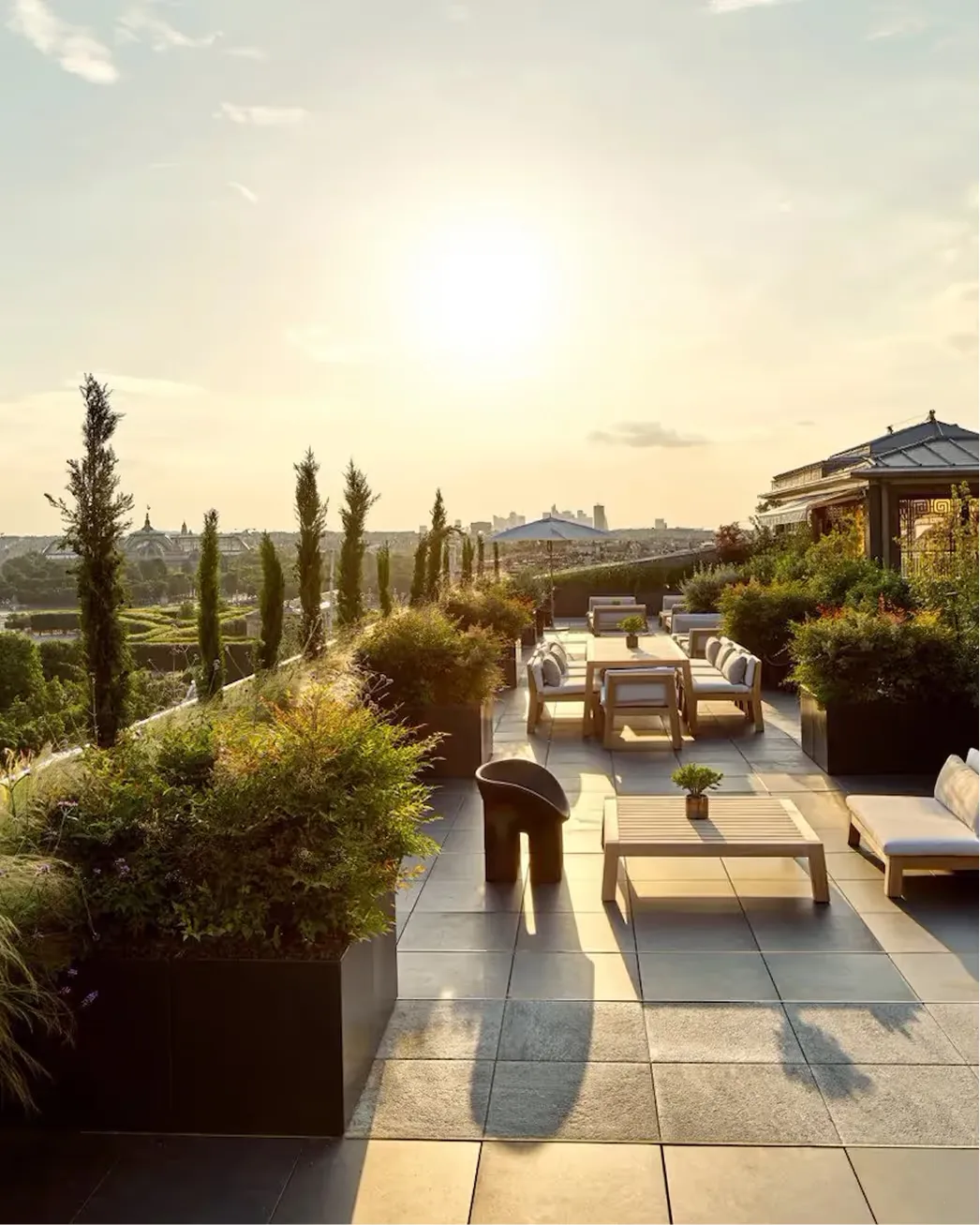 A rooftop terrace with cypress trees and Paris views, guests seated under shade structures