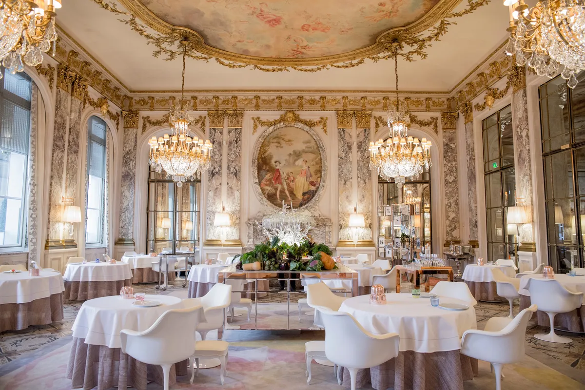 The grand dining room with ornate frescoed ceiling, classical proportions, and formal table settings