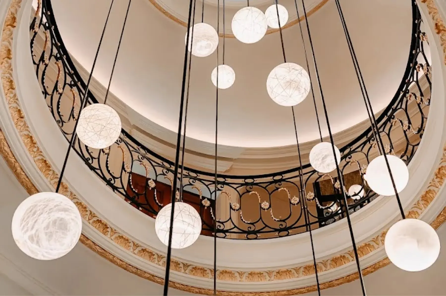 A central foyer with arched ceiling, pendant lights suspended above wooden and stone finishes