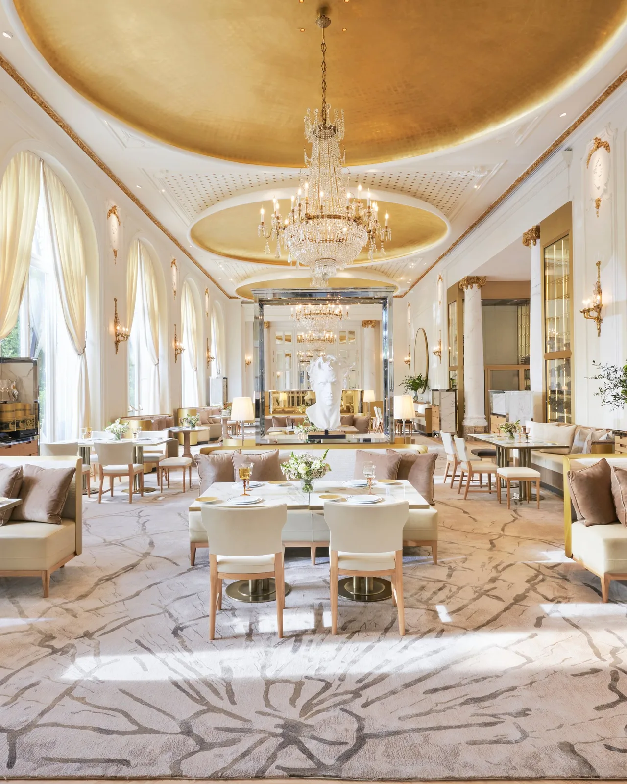 Soaring neoclassical dining room with marble floors and arched ceiling
