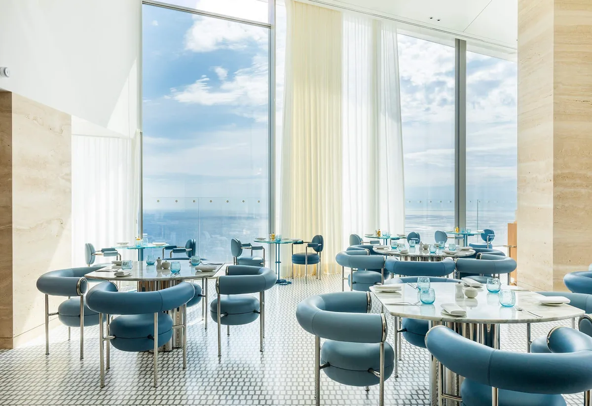 Fine dining restaurant with blue seating and Mediterranean vistas