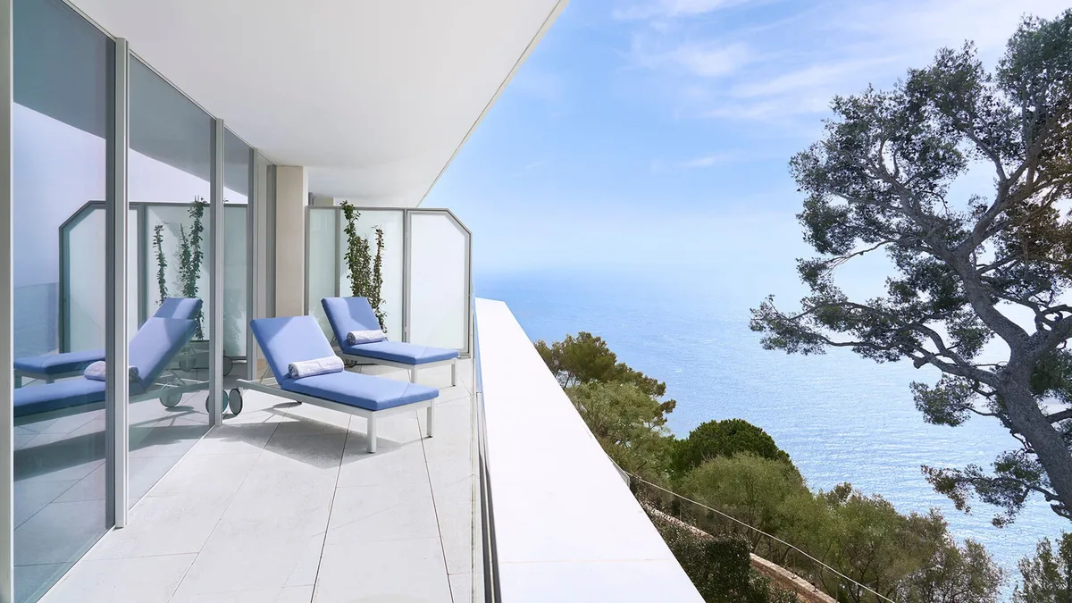 Balcony with two lounge chairs overlooking Mediterranean