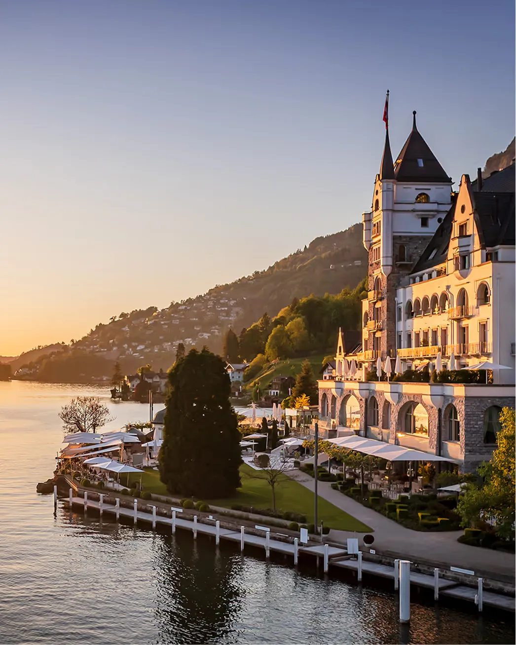 Golden-hour view of the castle-style hotel on Lake Lucerne’s shore
