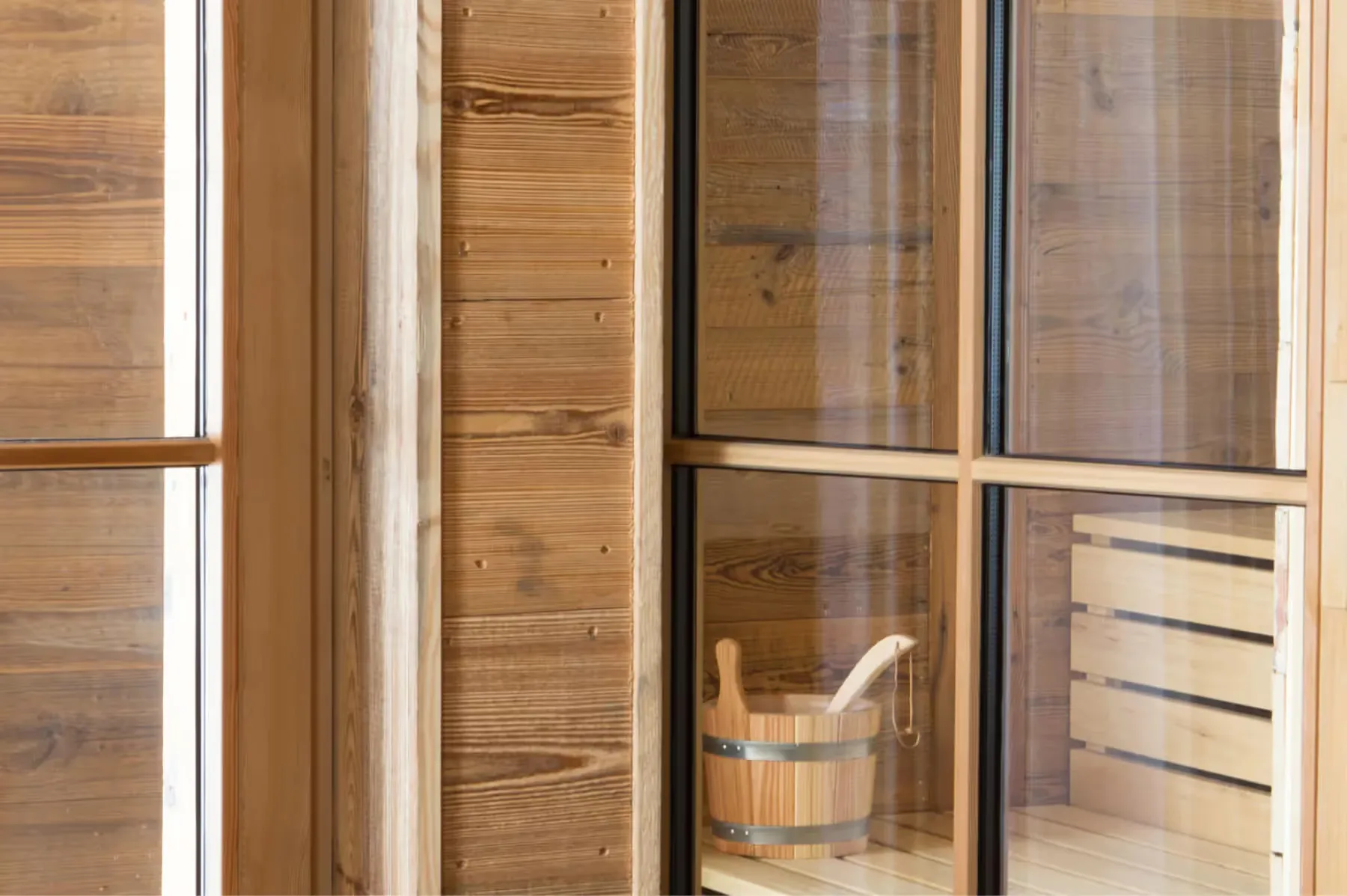 Wooden sauna interior with glass sliding doors