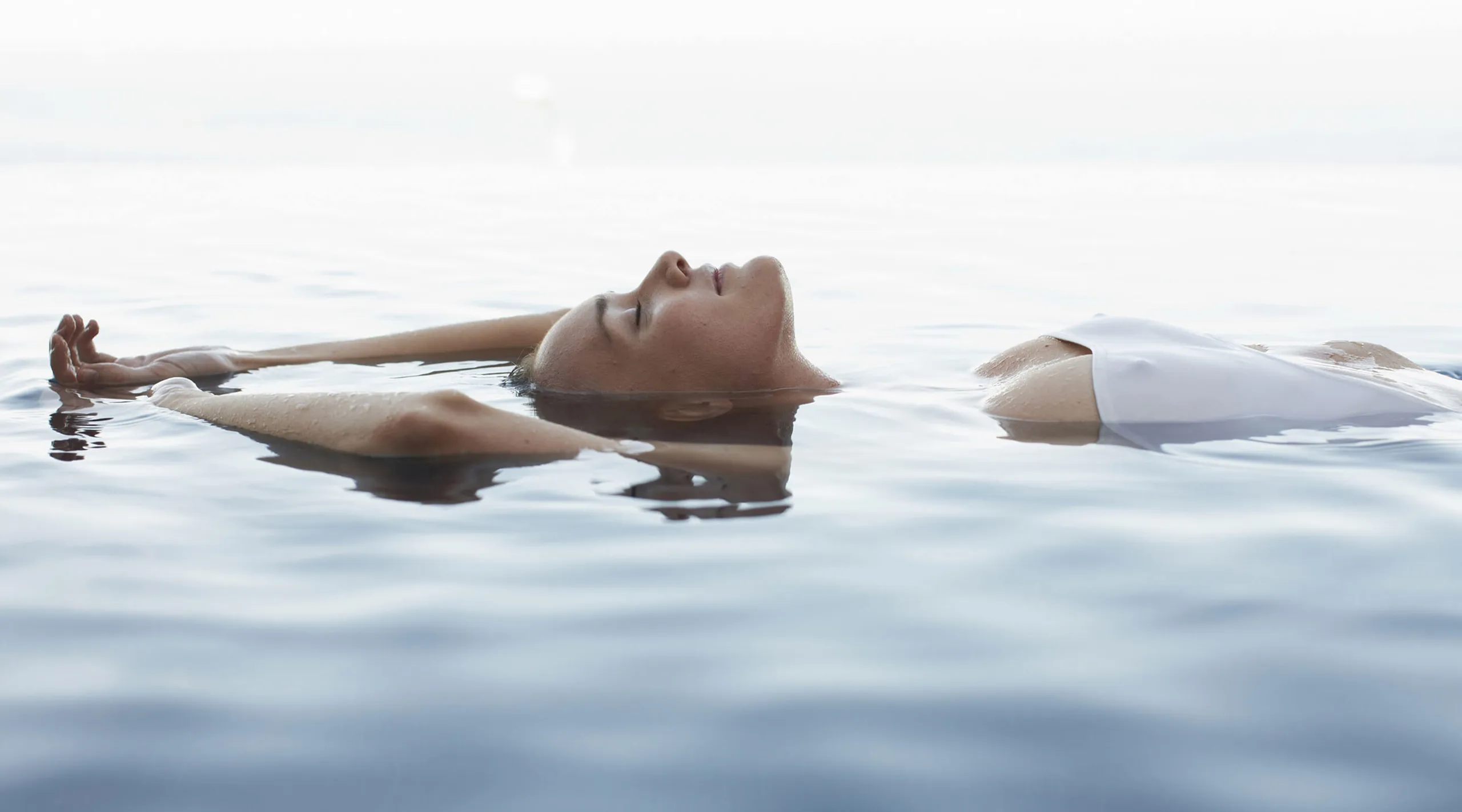 Person floating in an outdoor thermal pool