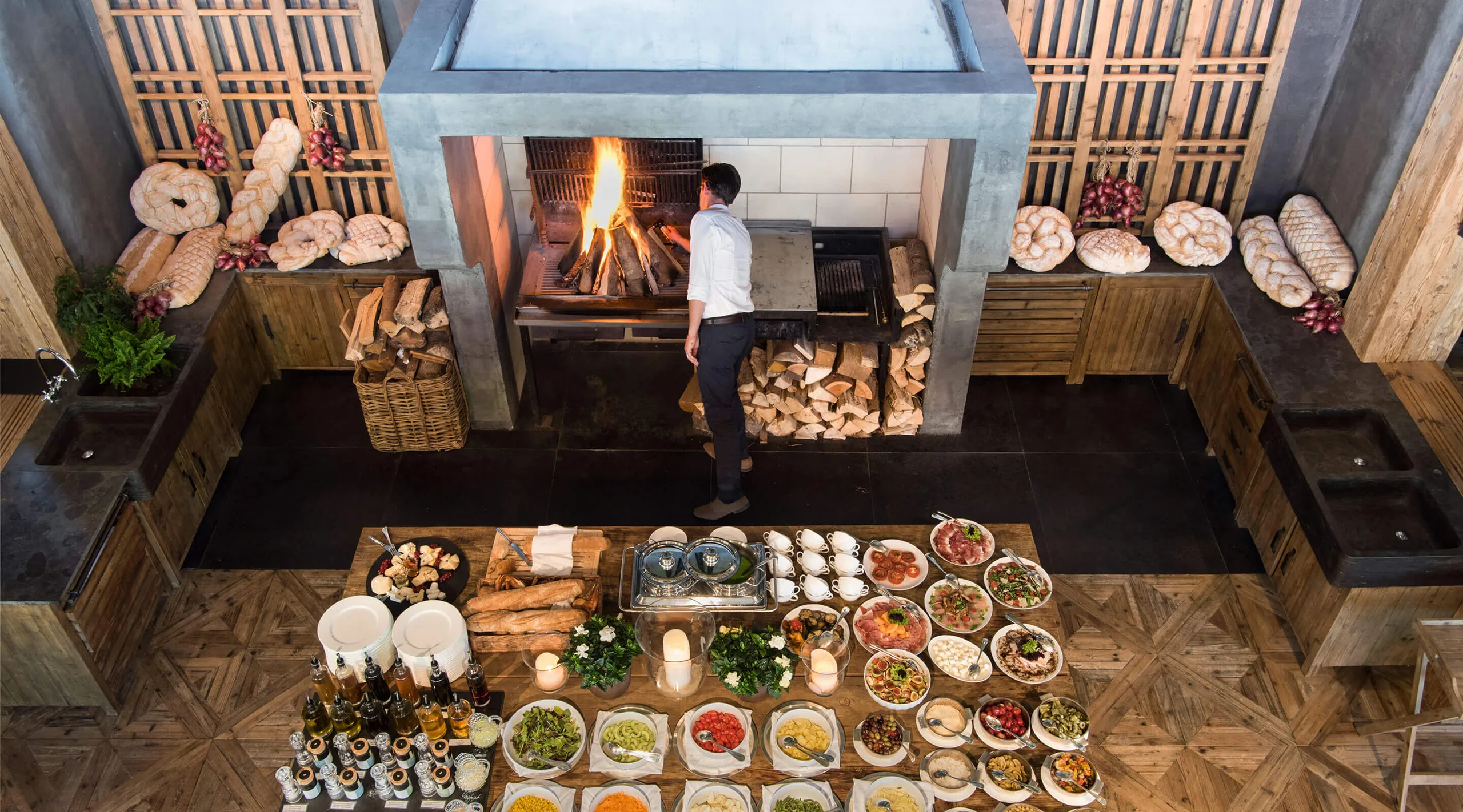 Overhead view of a dining area with fireplace and multiple plated courses