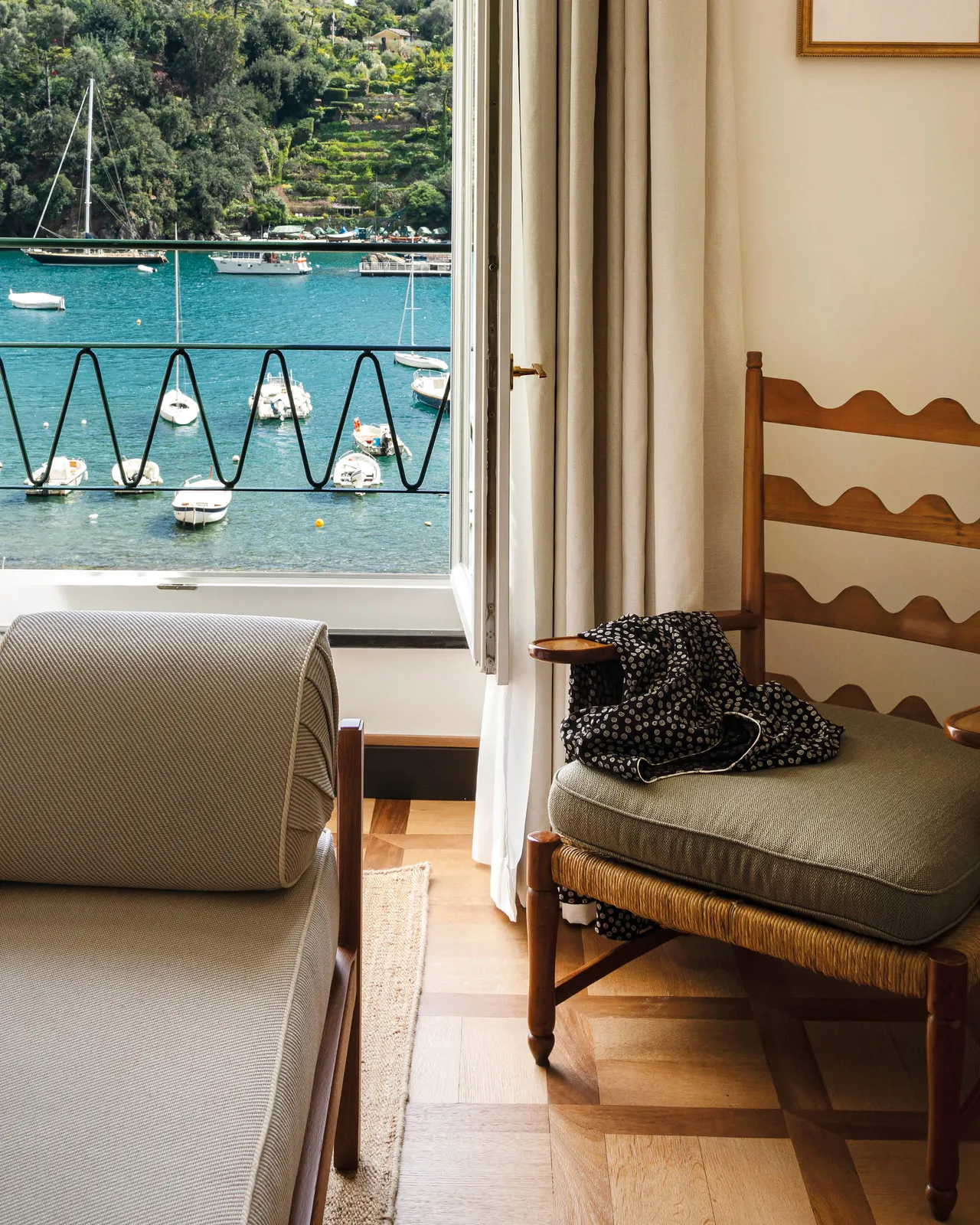 A room interior with chair looking toward sea-view balcony