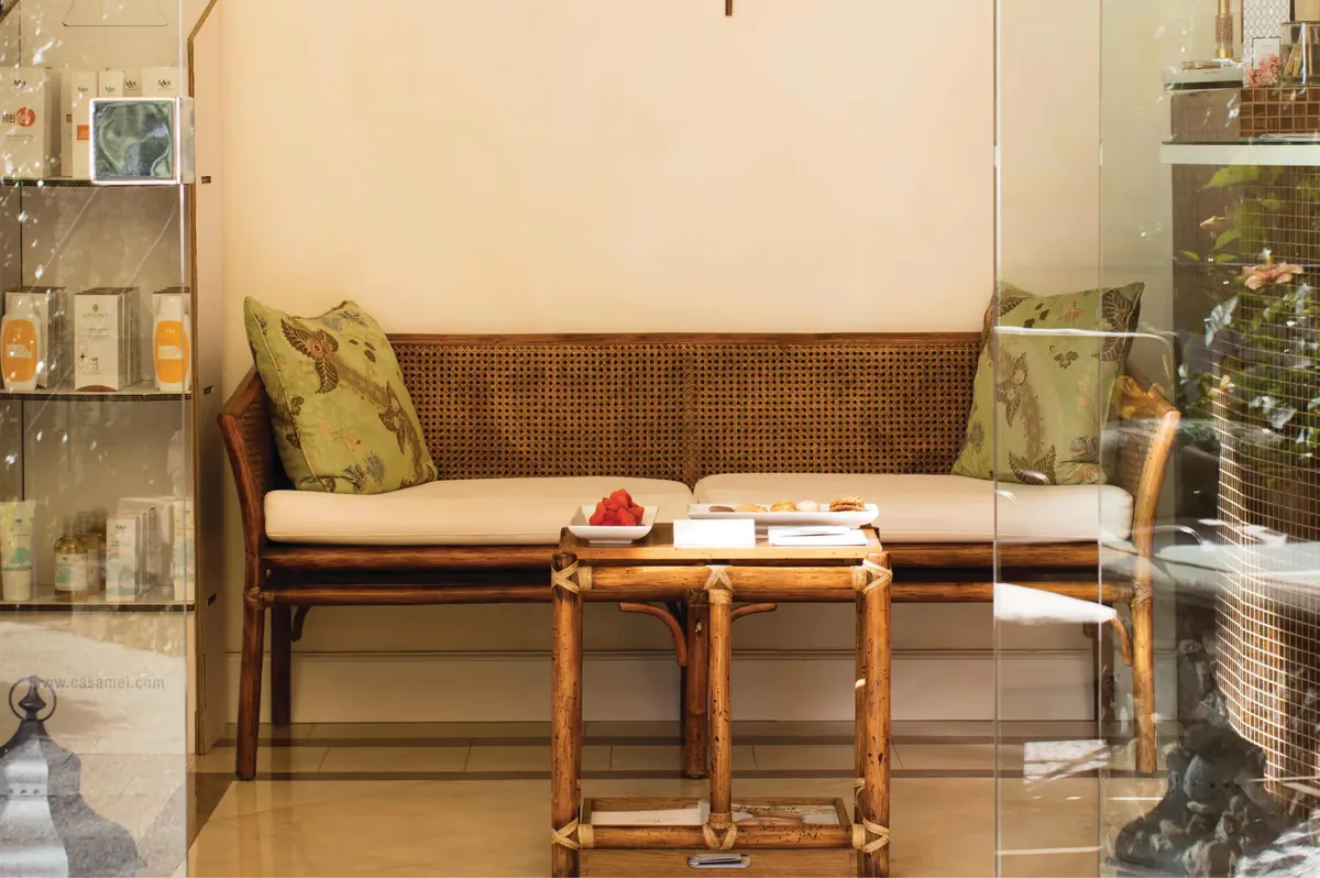 A spa treatment room with warm lighting and massage bed
