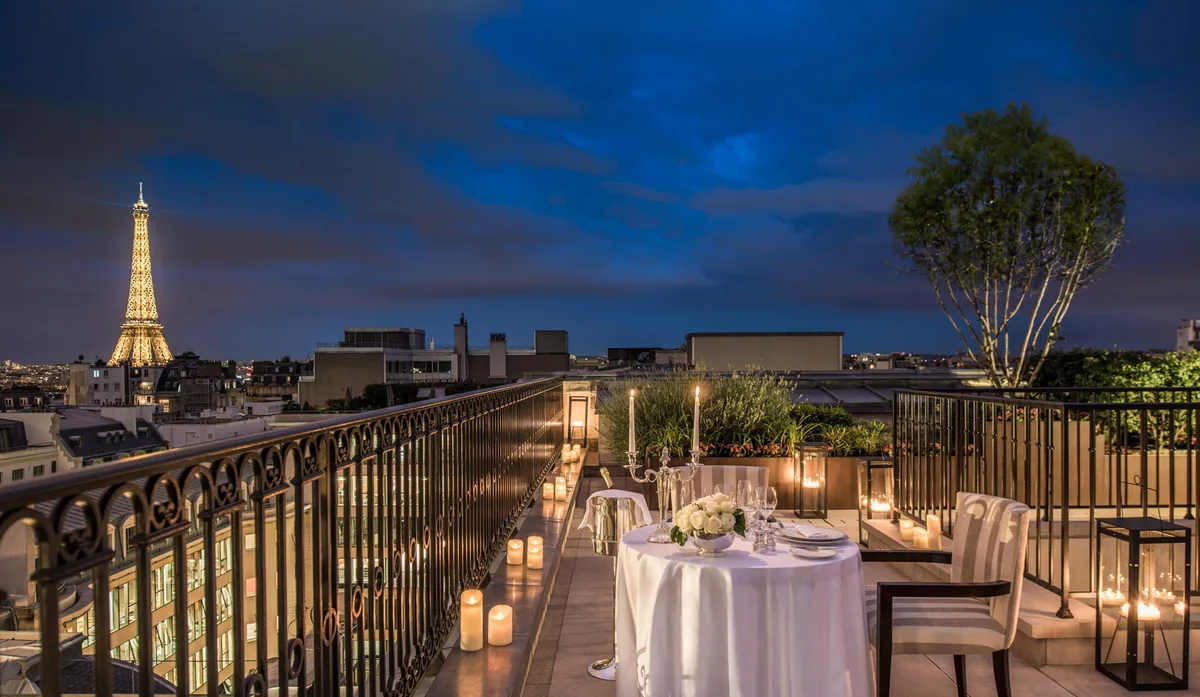 Indoor rooftop dining with floor-to-ceiling windows, city views, and elegant place settings
