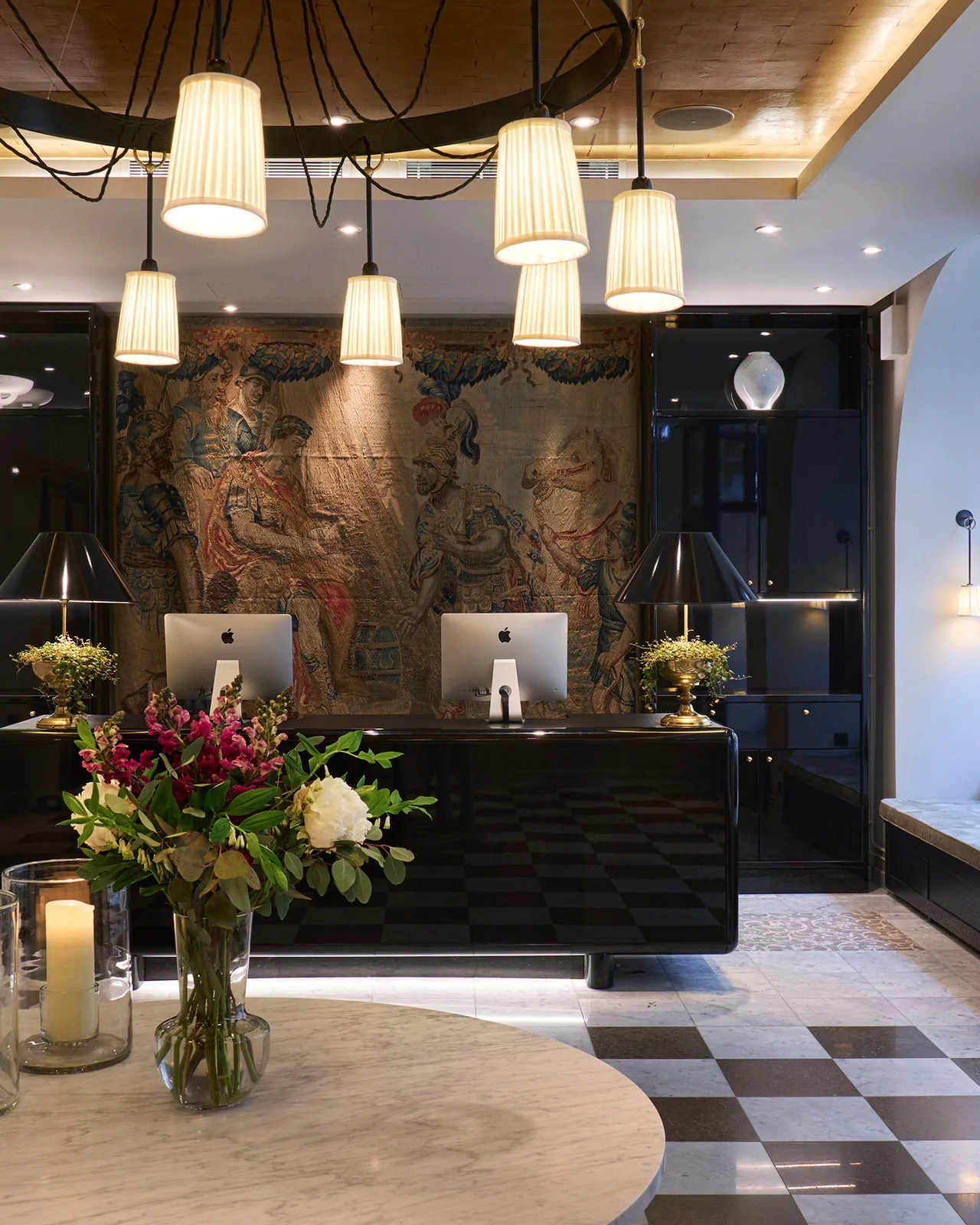 A vertical view of the reception desk with floral arrangement and arched ceiling