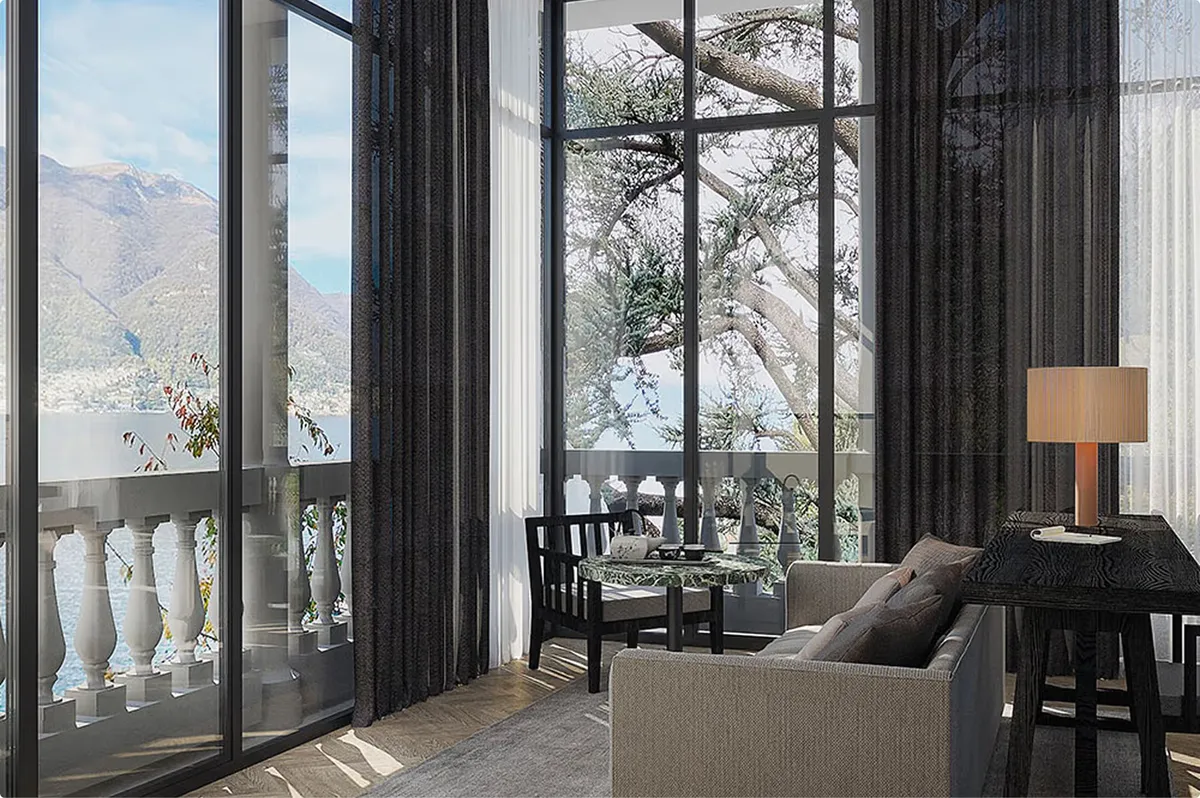 Suite with black drapery, gray seating, and expansive view to mountains and lake