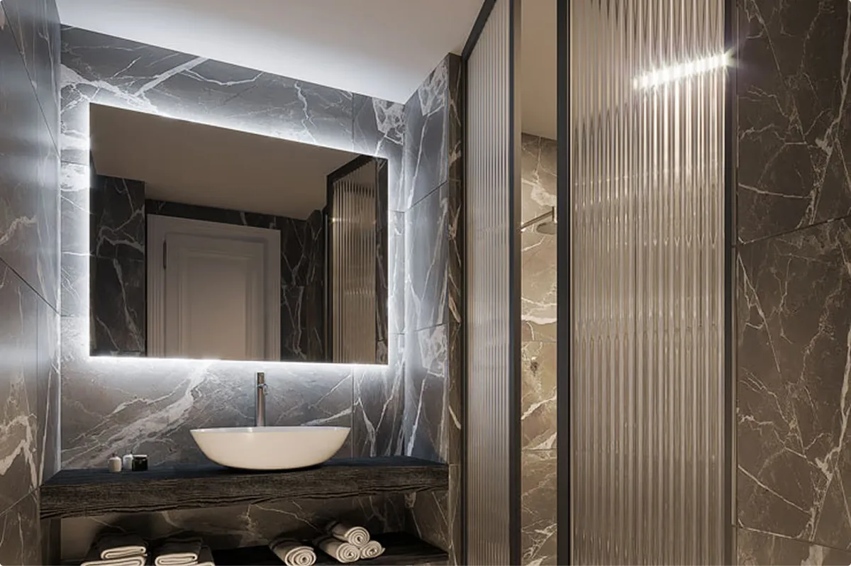 Marble bathroom with black tile accents and sculptural limestone basin